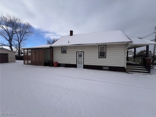 snow covered property featuring a porch