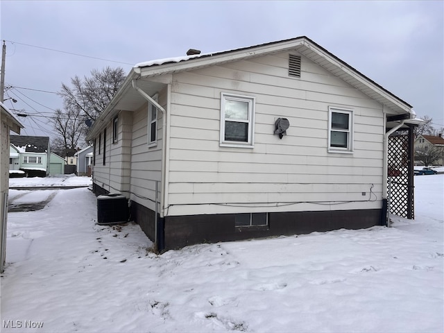 view of snow covered exterior with central air condition unit