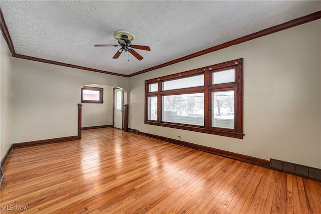 unfurnished room with ornamental molding, a textured ceiling, ceiling fan, and light hardwood / wood-style floors