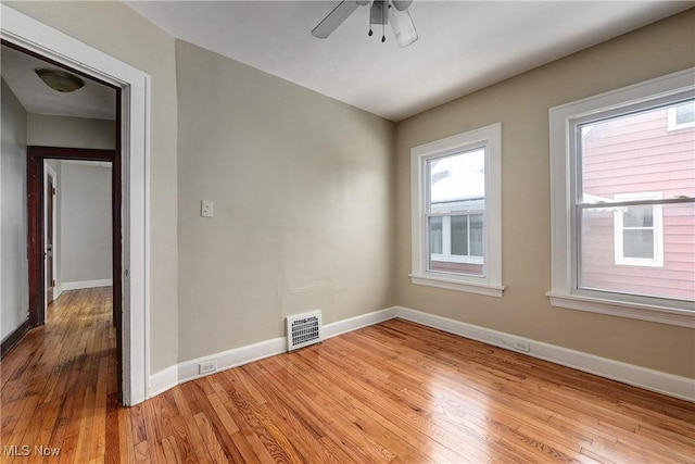 unfurnished room with ceiling fan and light wood-type flooring