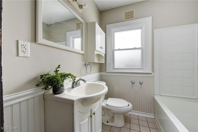 bathroom featuring vanity, tile patterned flooring, and toilet