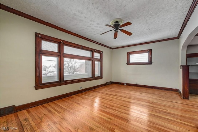 spare room featuring crown molding, a textured ceiling, ceiling fan, and light hardwood / wood-style flooring