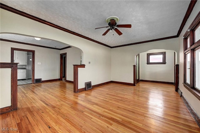 unfurnished living room featuring a textured ceiling, ceiling fan, light wood-type flooring, and crown molding