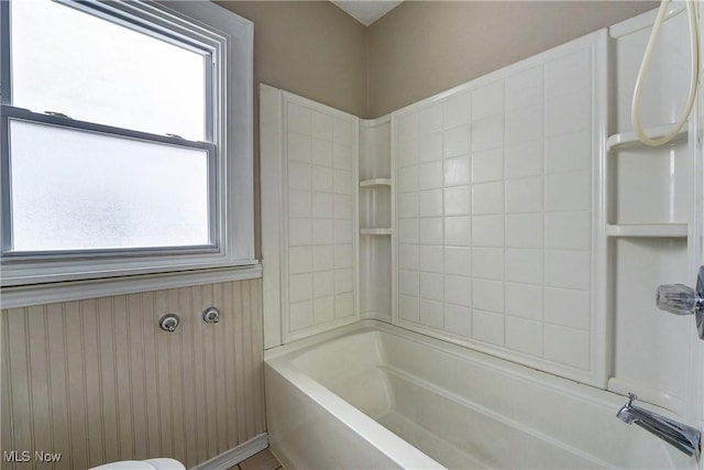 bathroom featuring washtub / shower combination and plenty of natural light