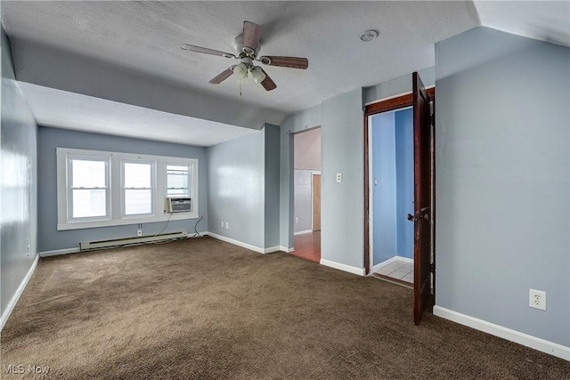 interior space with lofted ceiling, baseboard heating, dark colored carpet, and ceiling fan