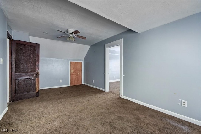 bonus room with lofted ceiling, carpet flooring, a textured ceiling, and ceiling fan