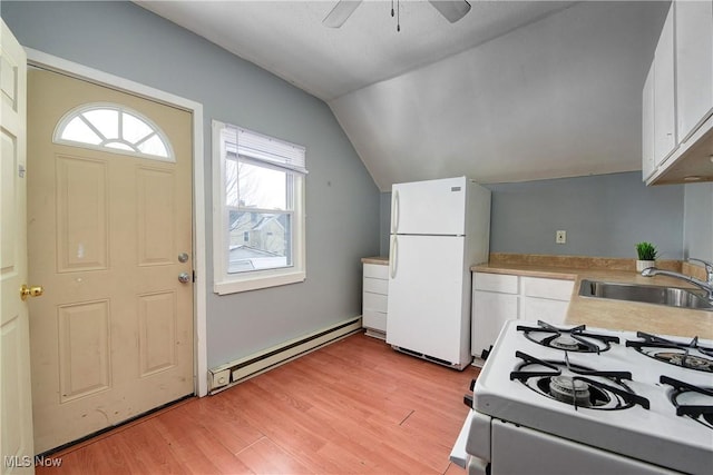 kitchen with white appliances, lofted ceiling, a baseboard heating unit, white cabinetry, and sink