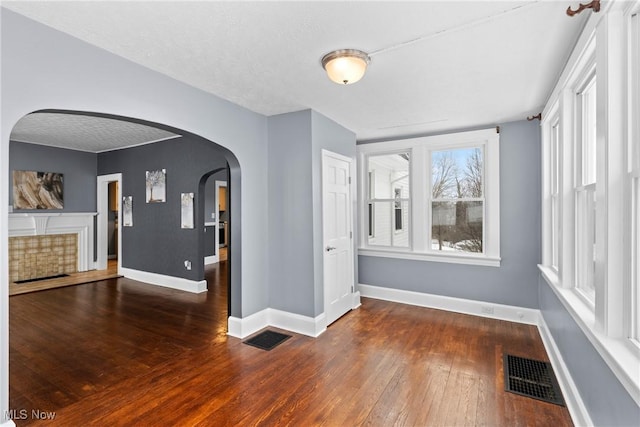 unfurnished room with dark hardwood / wood-style floors