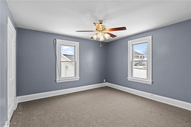 carpeted spare room with ceiling fan