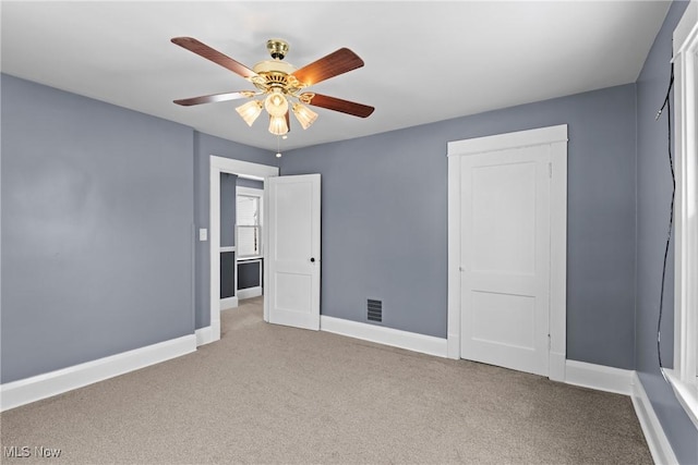 unfurnished bedroom featuring light carpet and ceiling fan