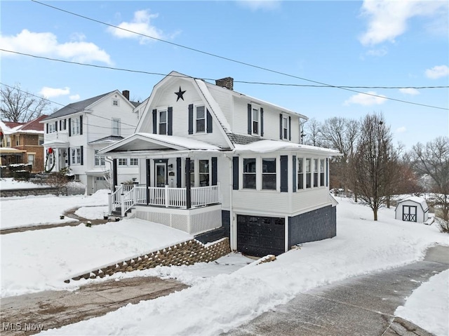 view of front of property featuring a garage and a porch