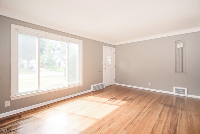 unfurnished room featuring hardwood / wood-style flooring