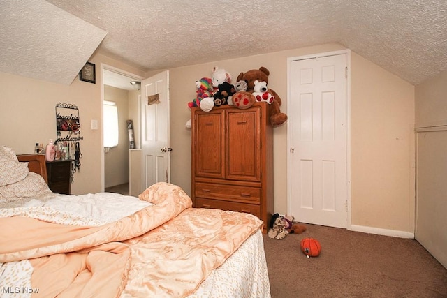 carpeted bedroom with lofted ceiling and a textured ceiling