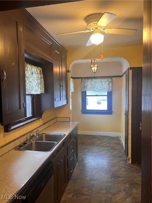 kitchen featuring sink, dishwasher, ceiling fan, backsplash, and dark brown cabinetry