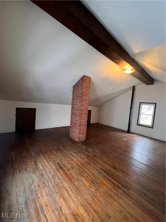 additional living space with lofted ceiling with beams and dark hardwood / wood-style floors