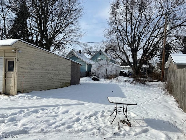 view of yard layered in snow