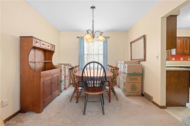 carpeted dining room with a notable chandelier