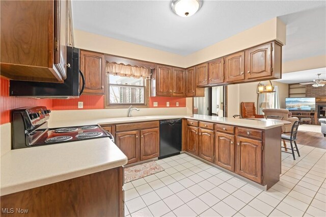 kitchen featuring dishwasher, stainless steel electric stove, kitchen peninsula, ceiling fan, and sink