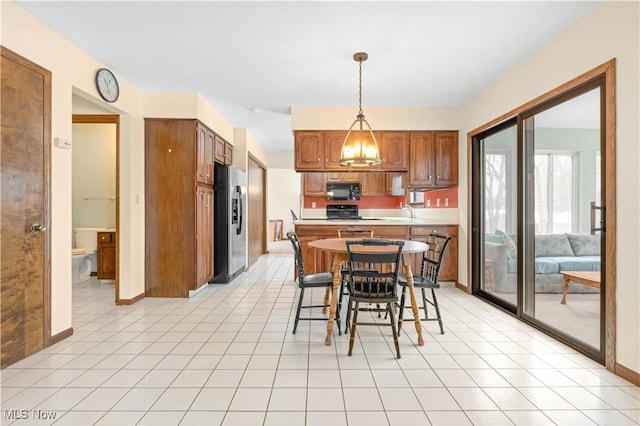 tiled dining room featuring a notable chandelier