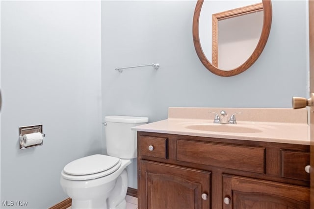 bathroom featuring tile patterned floors, vanity, and toilet