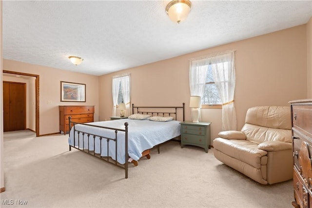 carpeted bedroom featuring a textured ceiling