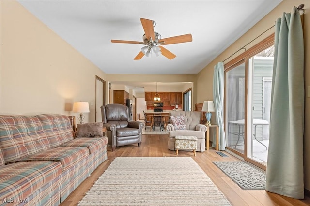 living room with ceiling fan and light hardwood / wood-style floors