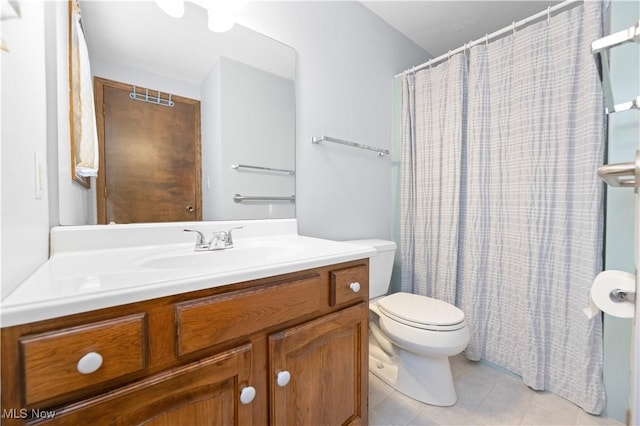 bathroom with tile patterned floors, vanity, and toilet