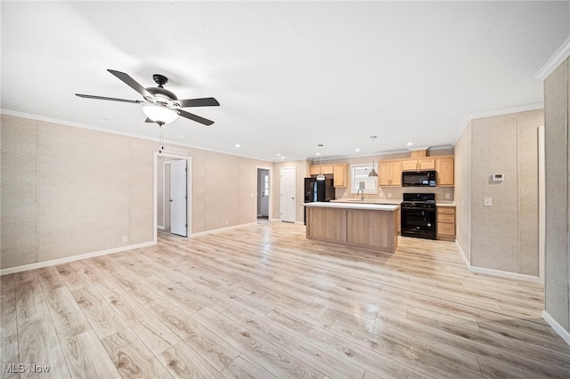 kitchen featuring decorative light fixtures, ornamental molding, a kitchen island, light hardwood / wood-style floors, and black appliances