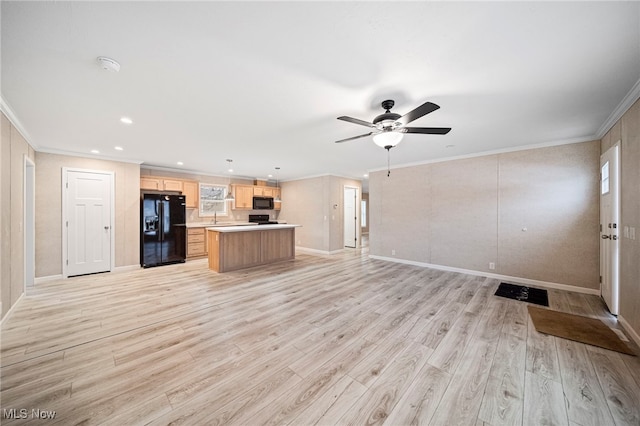 unfurnished living room with sink, crown molding, ceiling fan, and light wood-type flooring