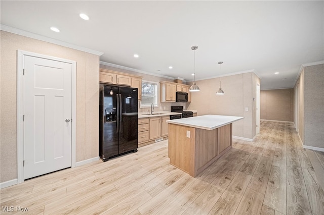 kitchen featuring a kitchen island, pendant lighting, sink, light hardwood / wood-style floors, and black appliances