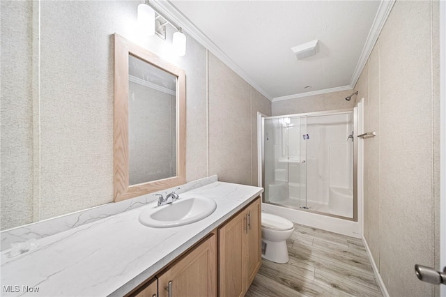 full bathroom featuring toilet, crown molding, vanity, enclosed tub / shower combo, and hardwood / wood-style floors