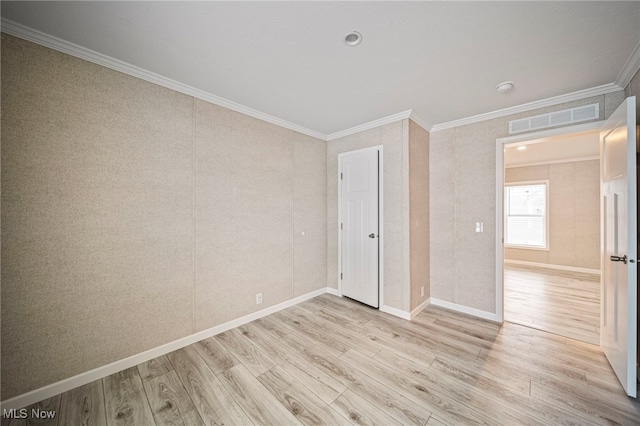 unfurnished bedroom with crown molding and light hardwood / wood-style floors