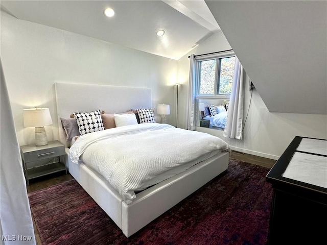 bedroom featuring dark wood-type flooring and lofted ceiling