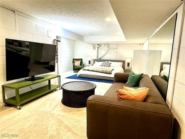 bedroom featuring a textured ceiling and carpet floors