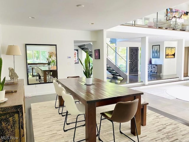 dining space featuring light wood-type flooring and a wealth of natural light