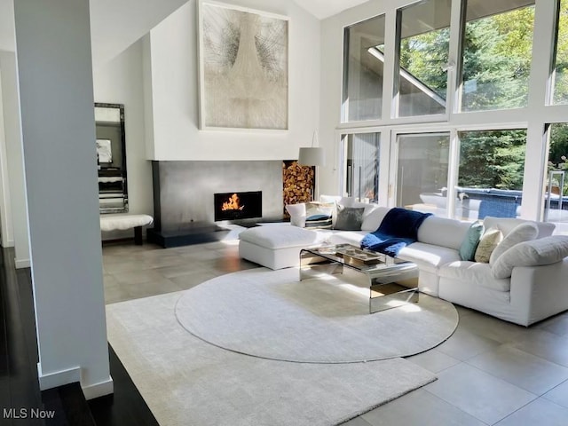 living room with a high ceiling and concrete flooring