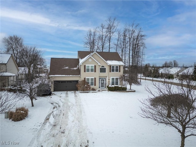 snow covered property featuring a garage