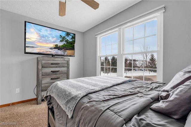 bedroom with a textured ceiling, carpet floors, and ceiling fan