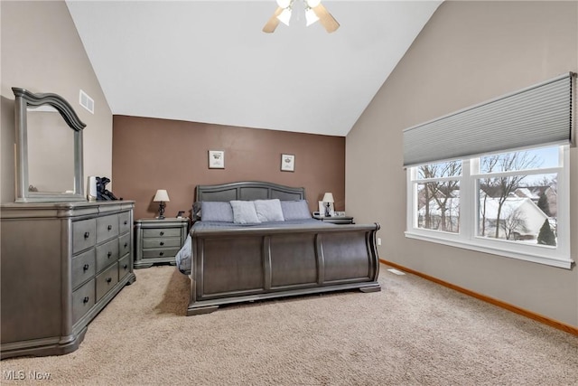 bedroom with ceiling fan, vaulted ceiling, and light colored carpet