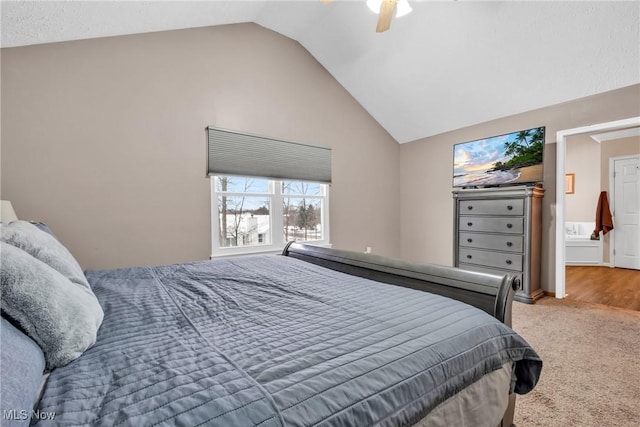 bedroom with ceiling fan, lofted ceiling, and carpet flooring