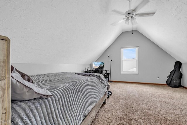 carpeted bedroom featuring a textured ceiling, ceiling fan, and vaulted ceiling