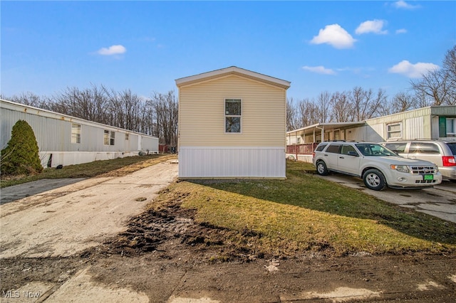 view of side of home featuring a yard