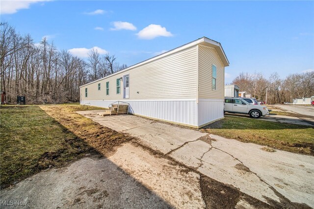 3583 Austin Rd Unit 134, Geneva, OH 44041 - view of side of home featuring a lawn