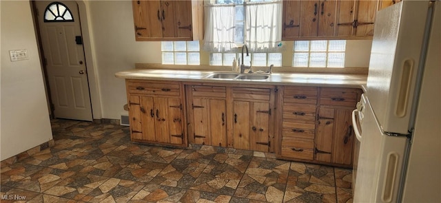 kitchen with sink and white fridge