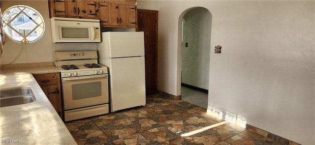 kitchen with sink and white appliances