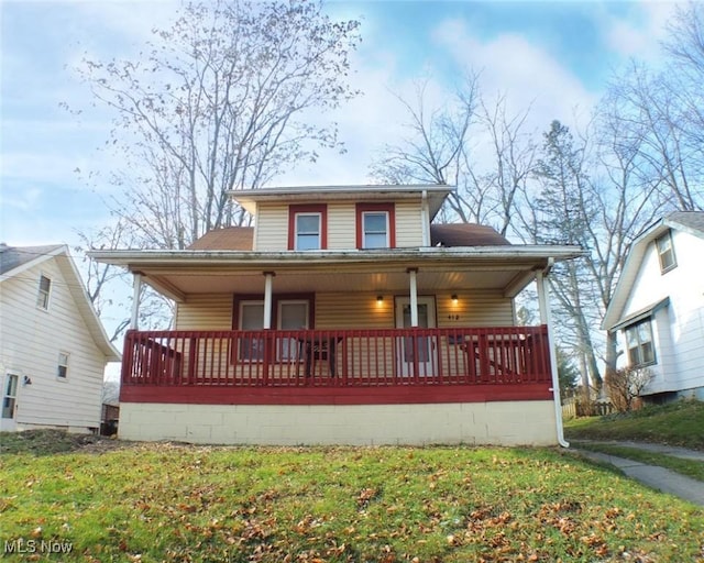 view of front of property with covered porch and a front lawn