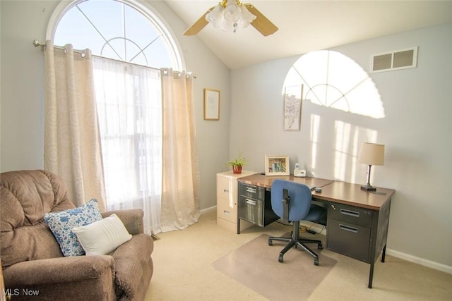 home office with vaulted ceiling, light colored carpet, and ceiling fan