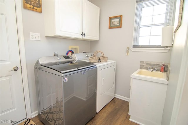 washroom with sink, cabinets, washer and clothes dryer, and dark hardwood / wood-style floors