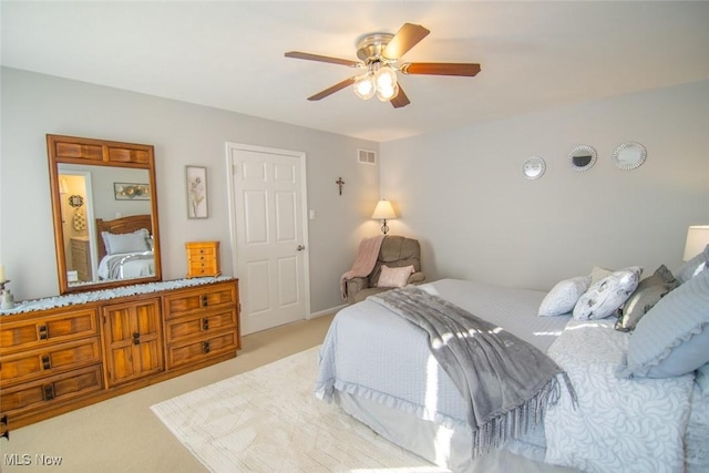 bedroom with ceiling fan and light colored carpet