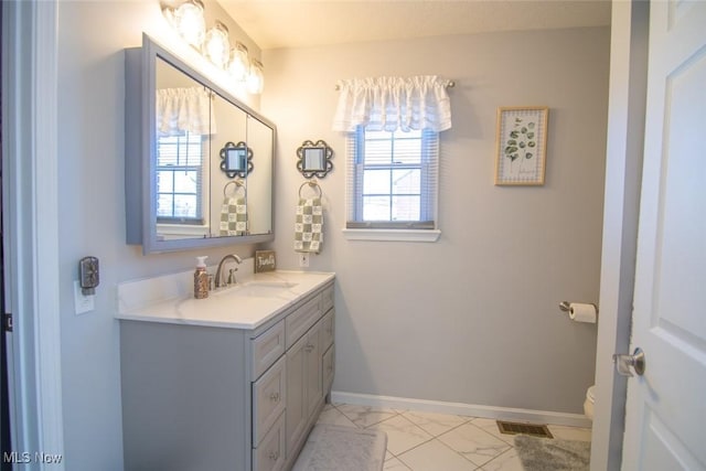 bathroom with toilet and vanity